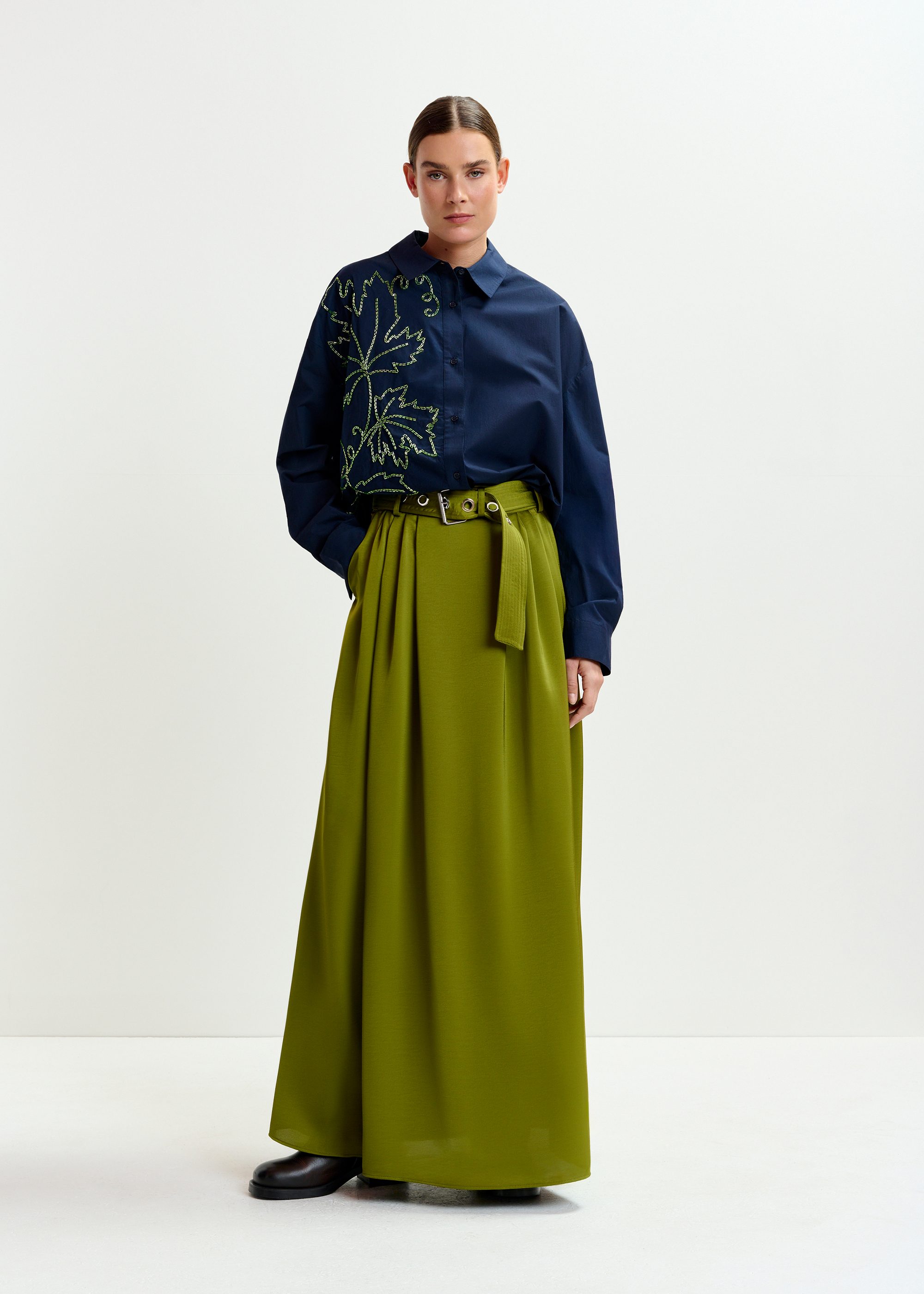 Olive green pleated ankle-length skirt with belted waist