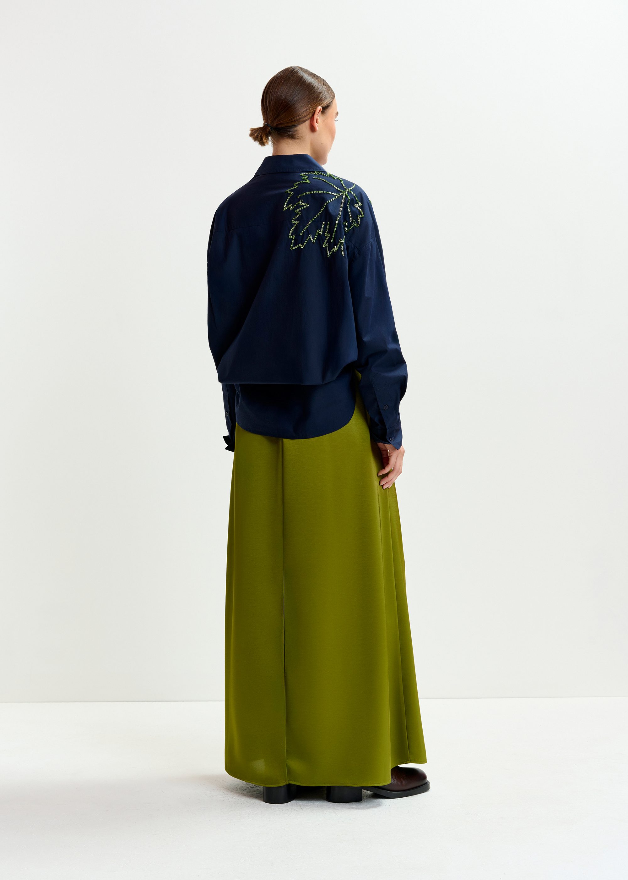 Olive green pleated ankle-length skirt with belted waist