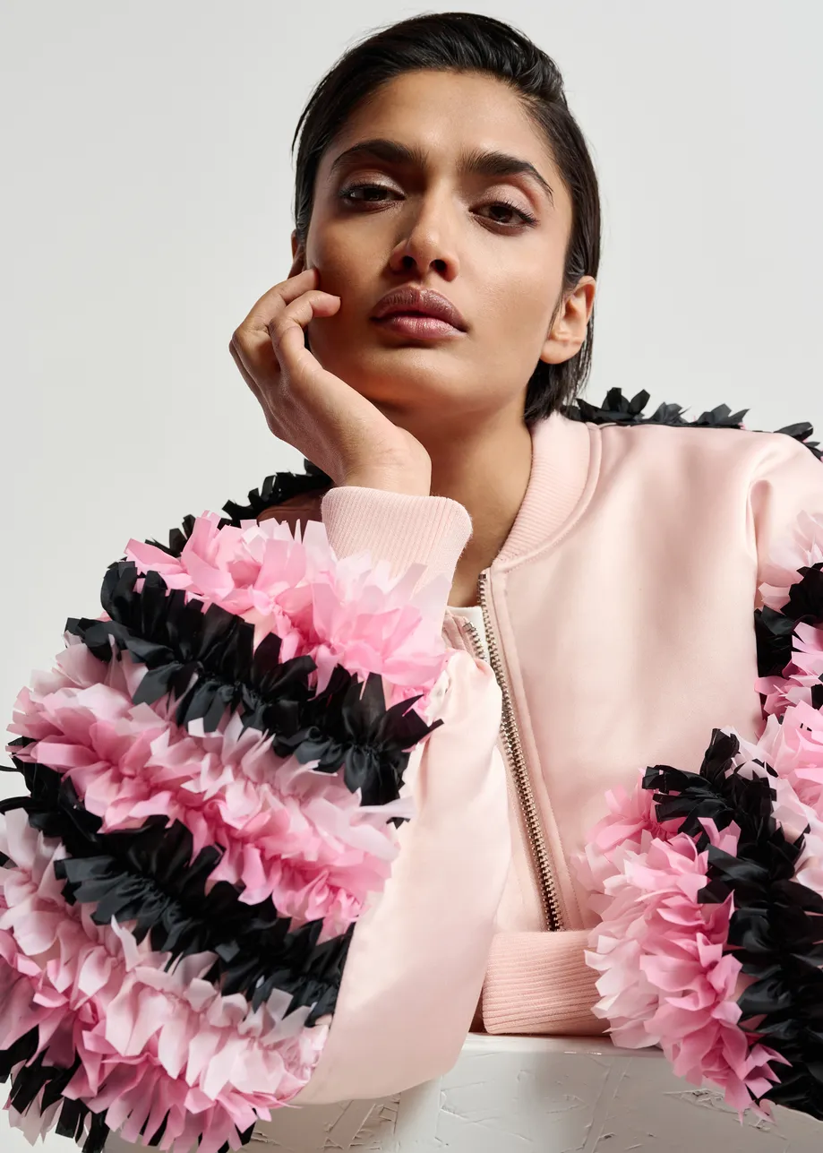 Champagne satin bomber jacket with pink and black ruffled inserts