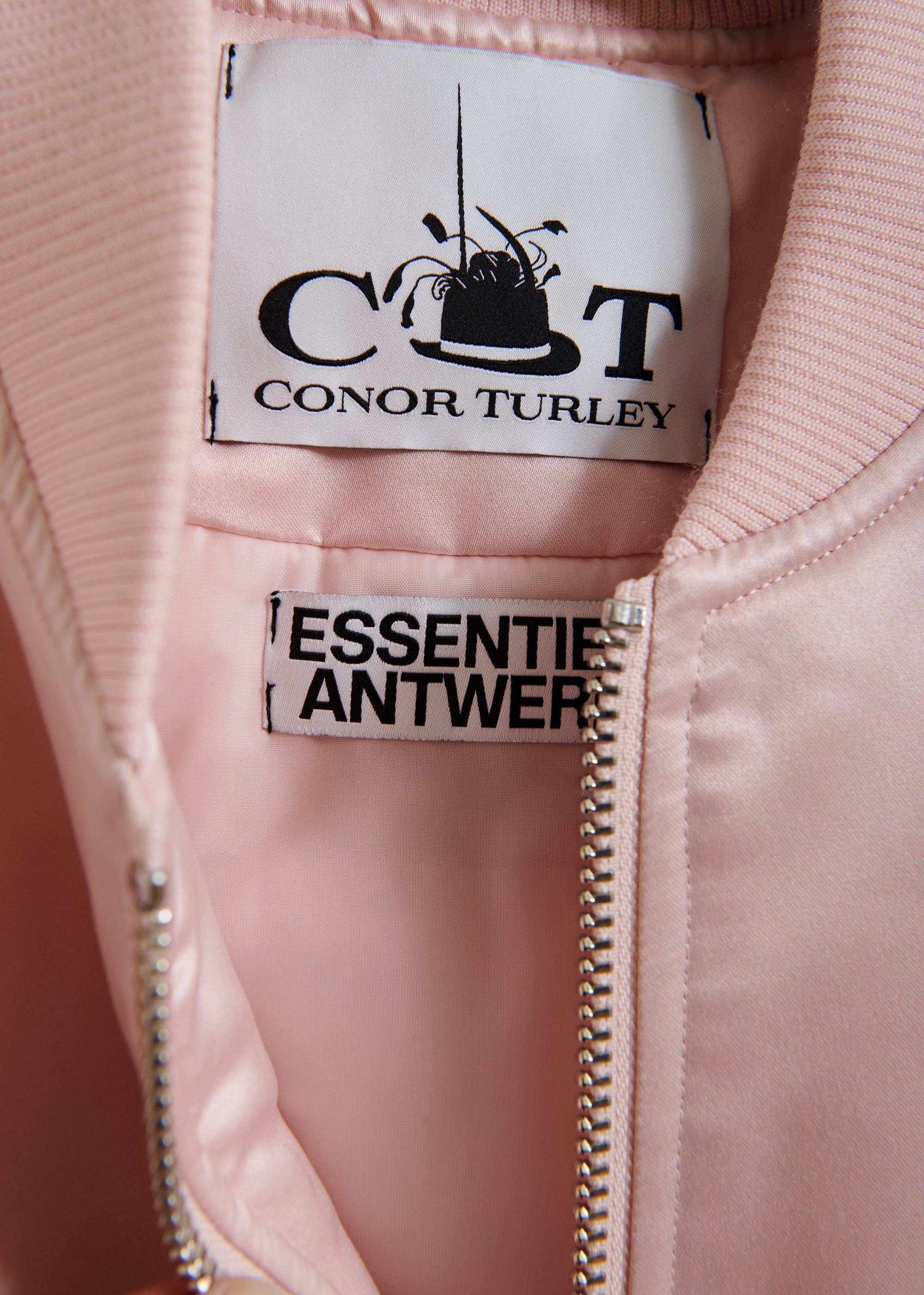 Champagne satin bomber jacket with pink and black ruffled inserts