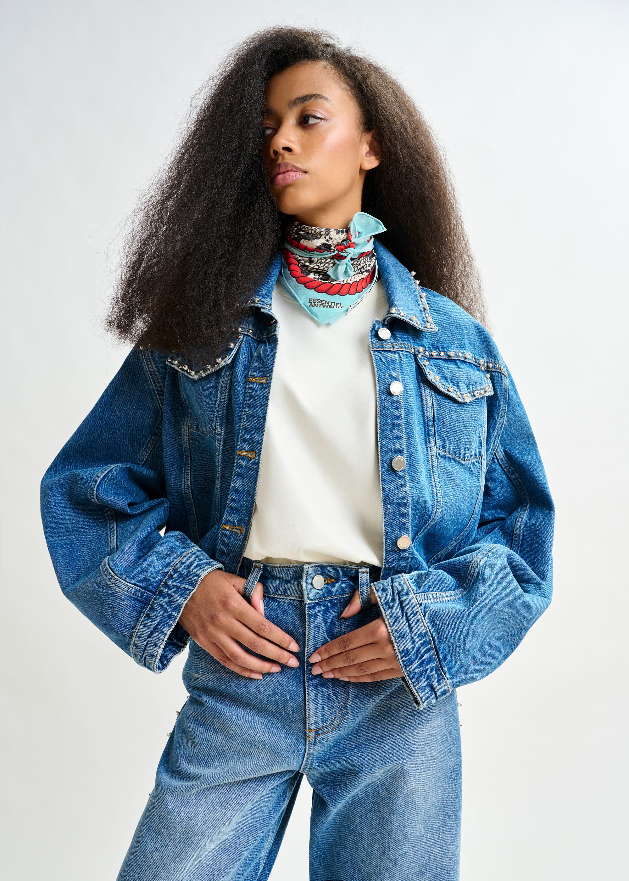 Blue cropped denim jacket with pearl and stud embellishments