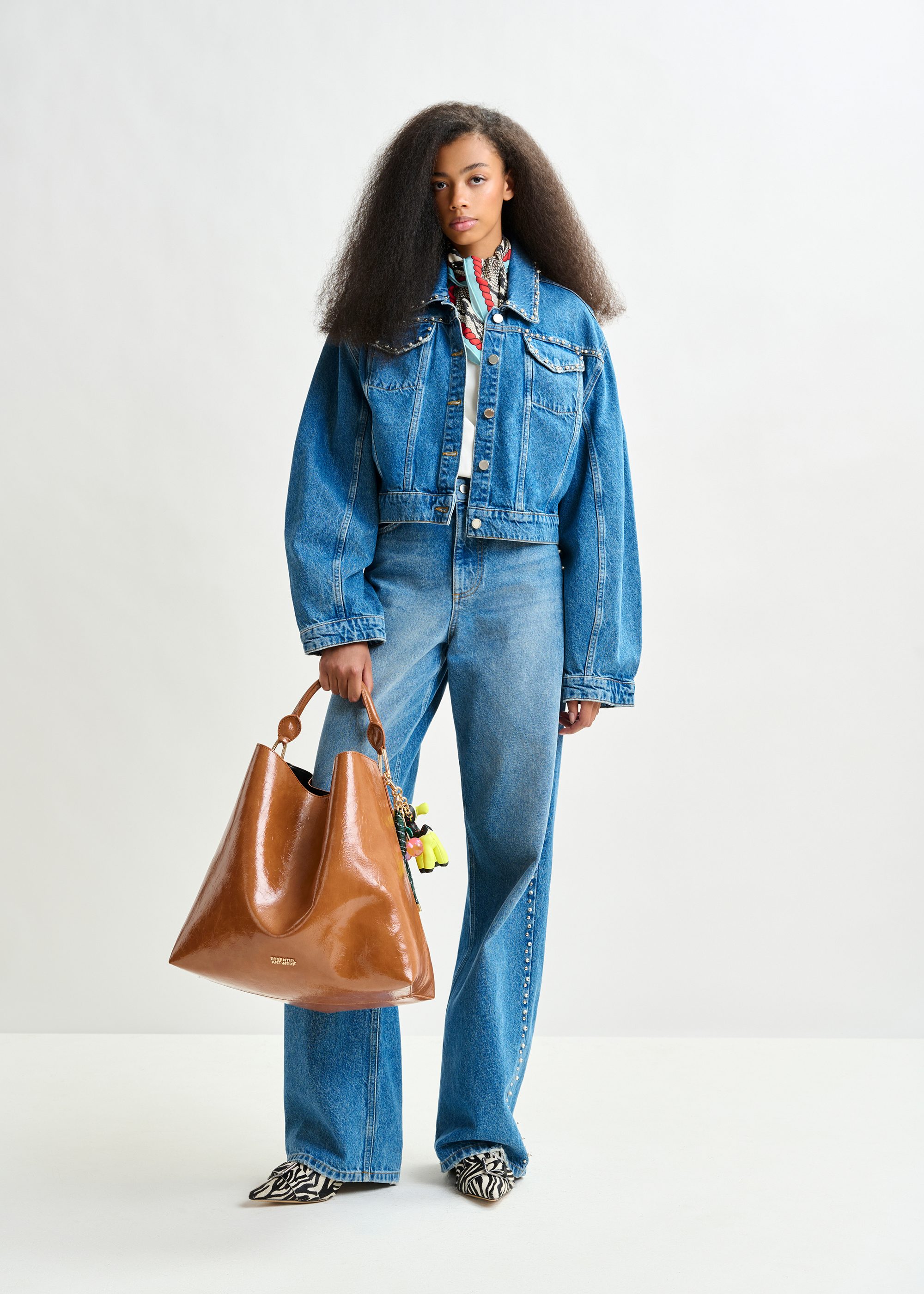 Blue cropped denim jacket with pearl and stud embellishments