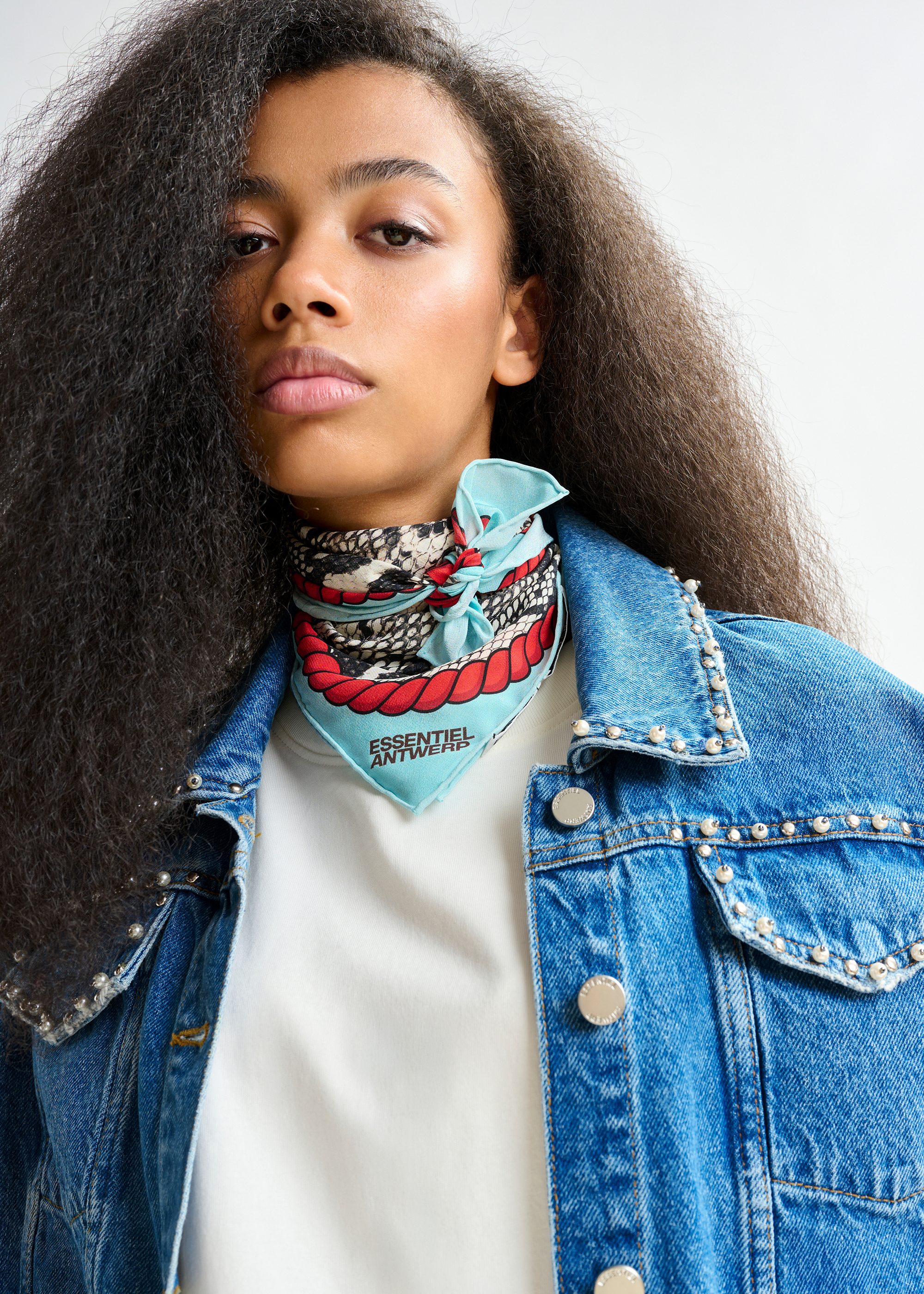 Blue cropped denim jacket with pearl and stud embellishments