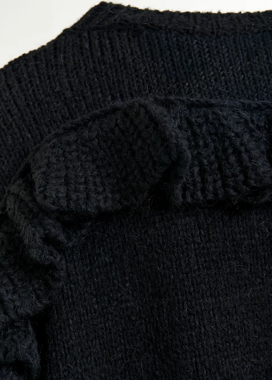 Black knit mini dress with ruffle detail