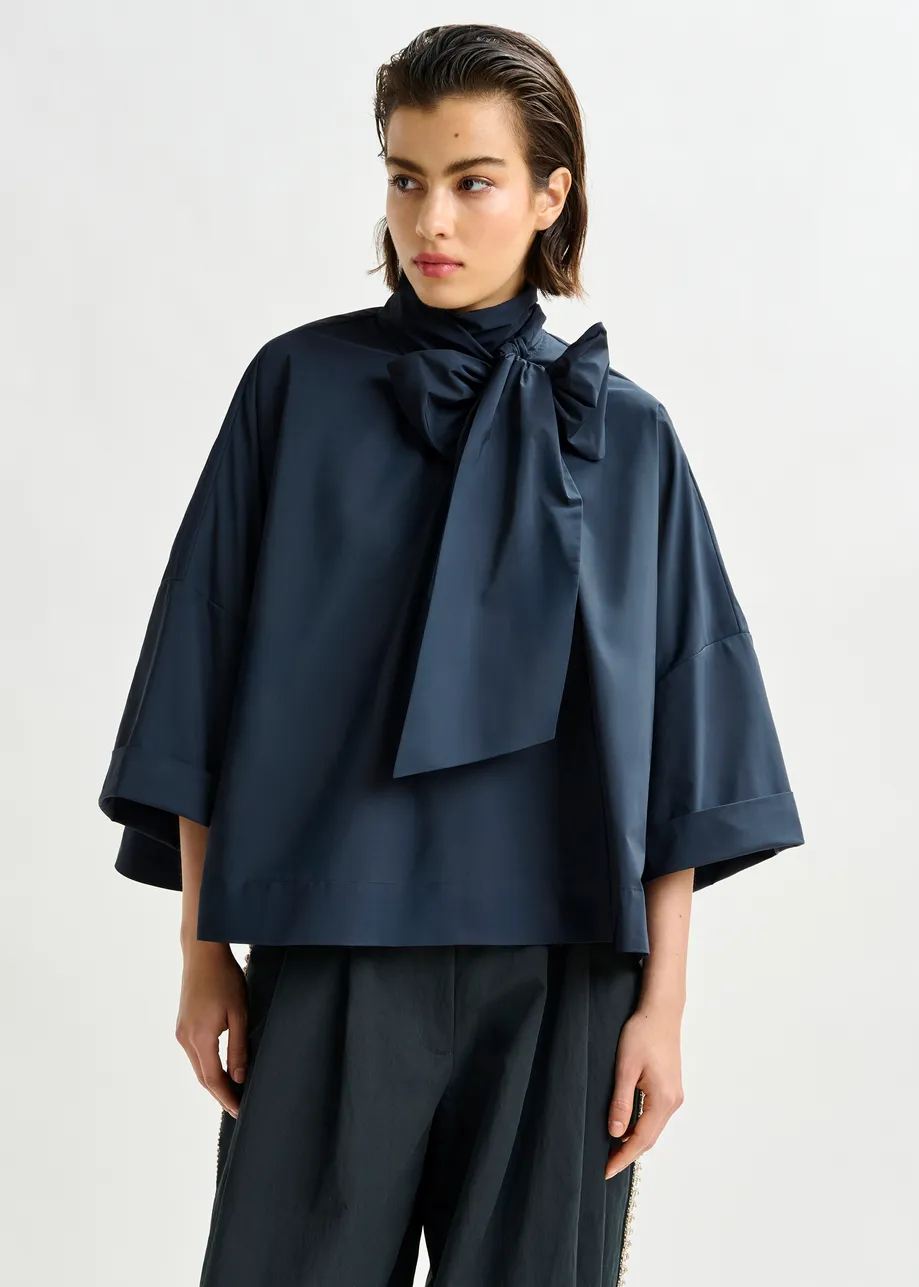 Navy pussy-bow top with trumpet sleeves