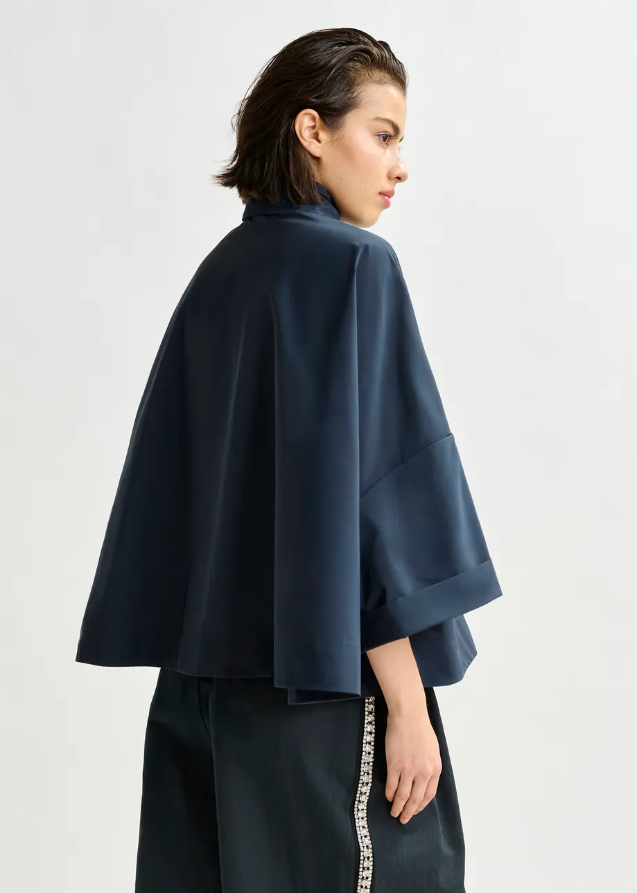 Navy pussy-bow top with trumpet sleeves