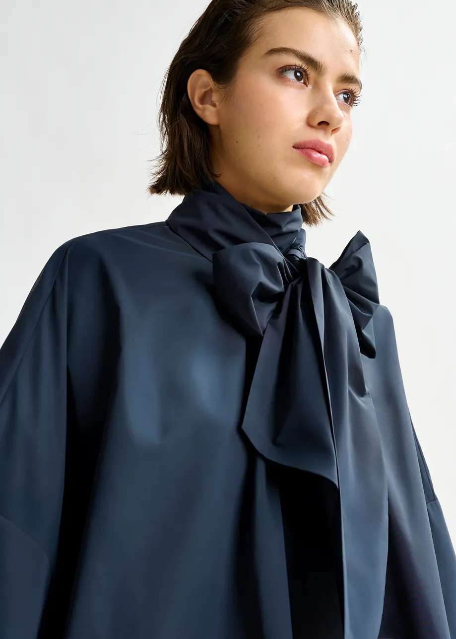 Navy pussy-bow top with trumpet sleeves