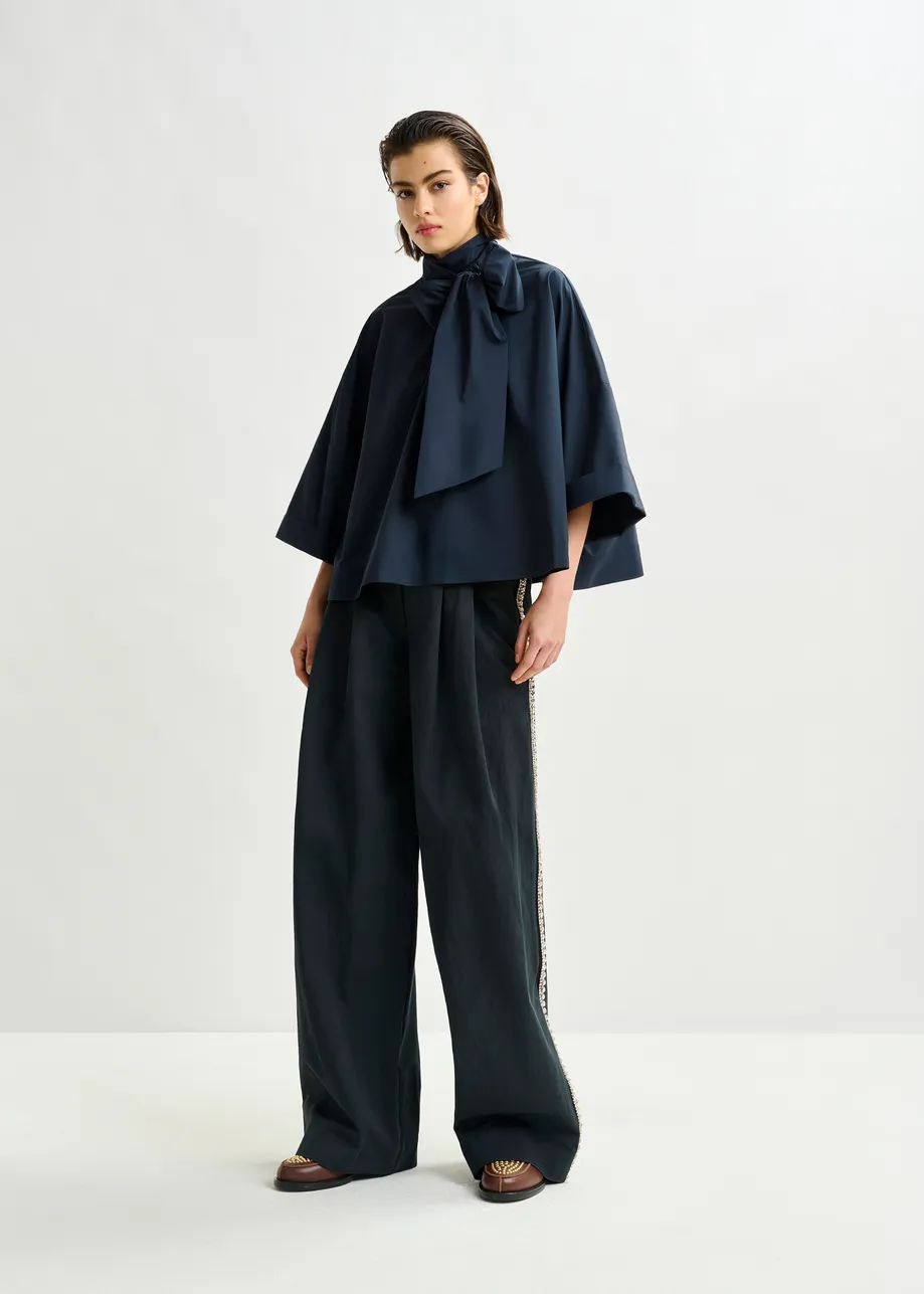 Navy pussy-bow top with trumpet sleeves