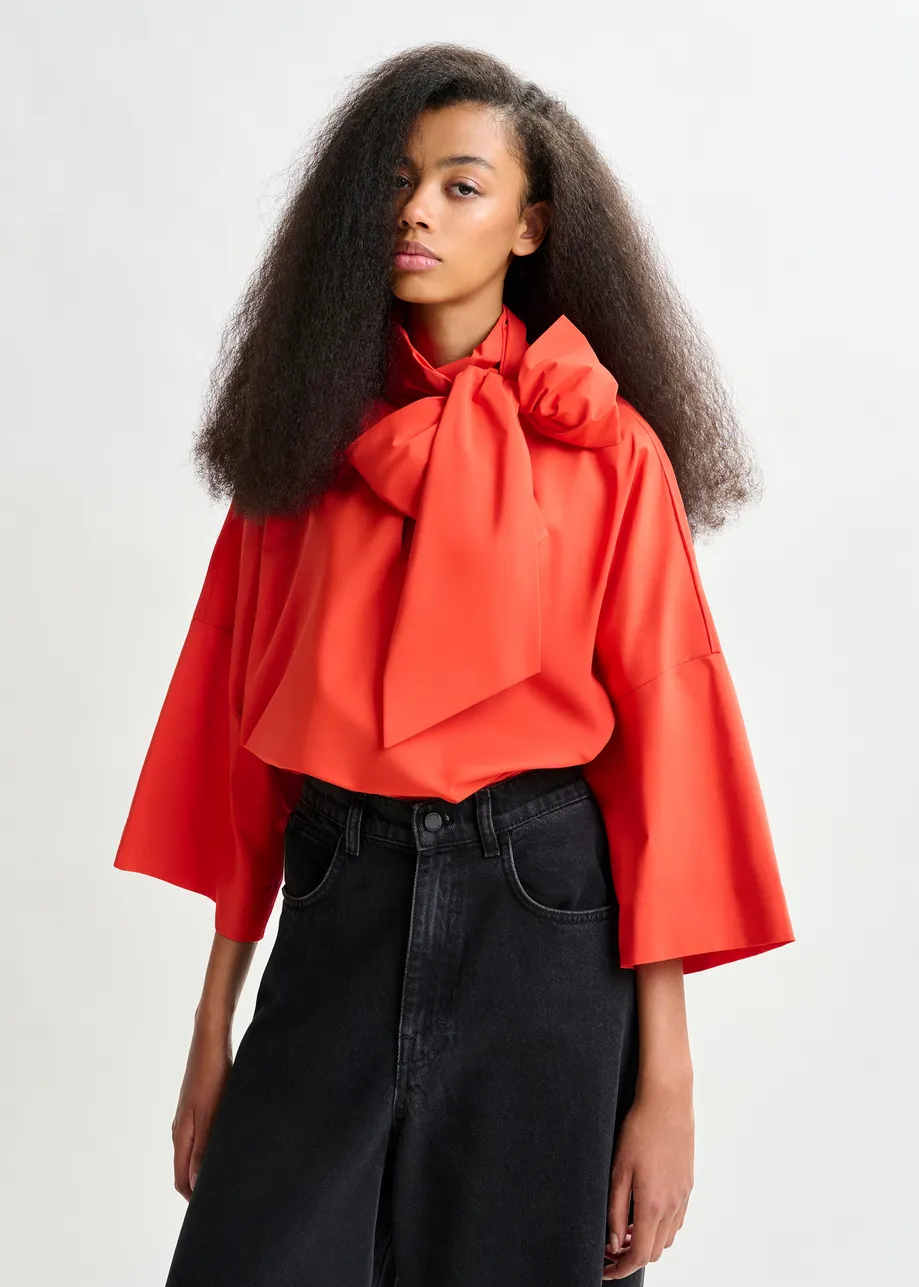 Red pussy-bow top with trumpet sleeves