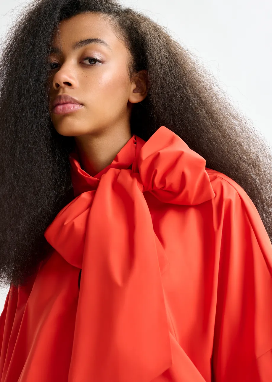 Red pussy-bow top with trumpet sleeves