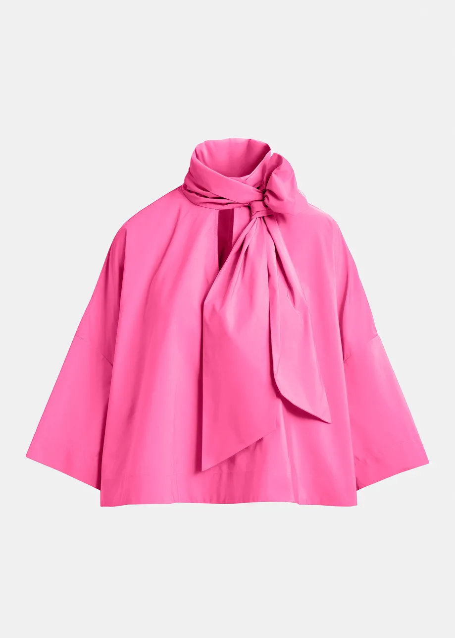Pink pussy-bow top with trumpet sleeves