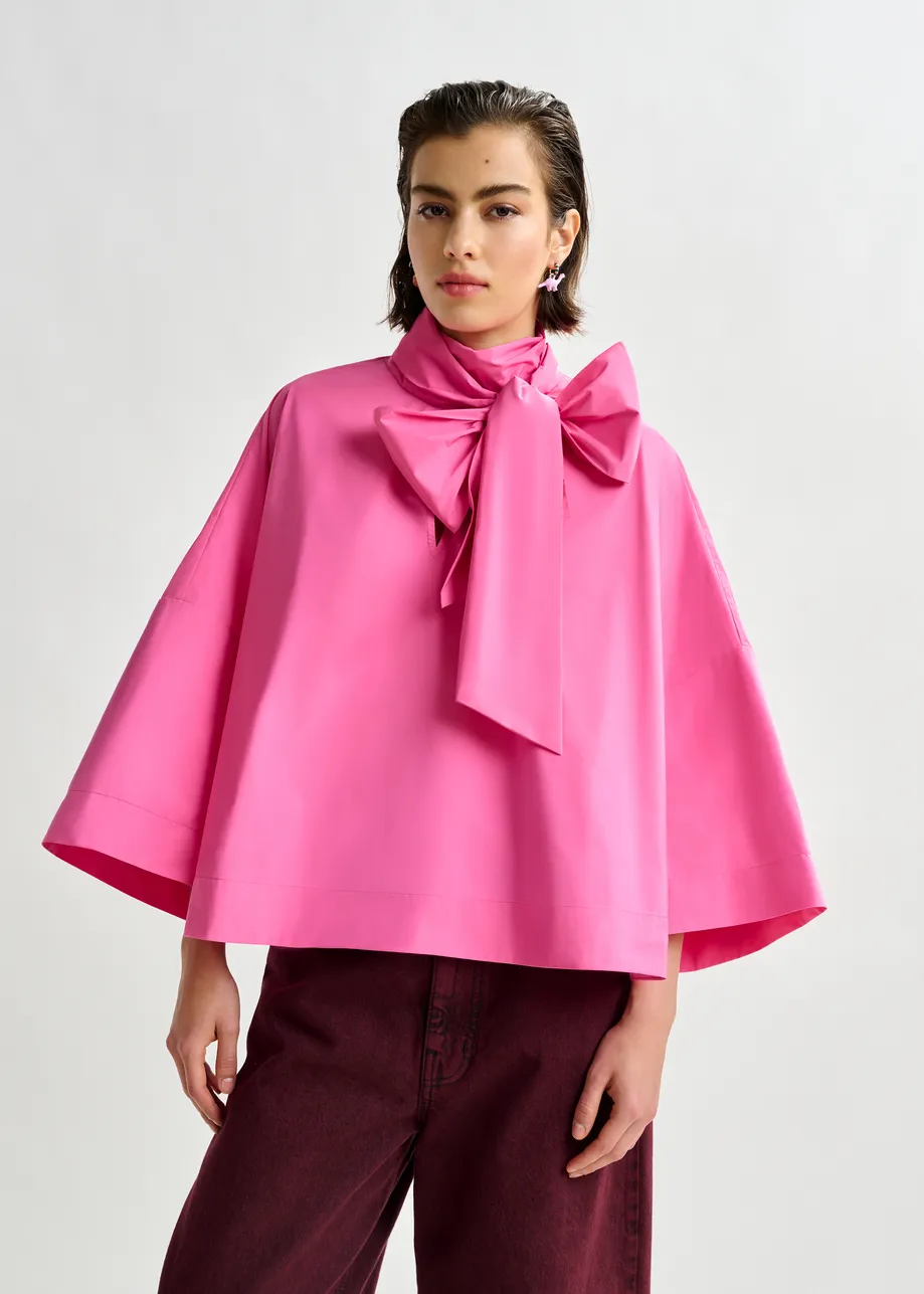Pink pussy-bow top with trumpet sleeves