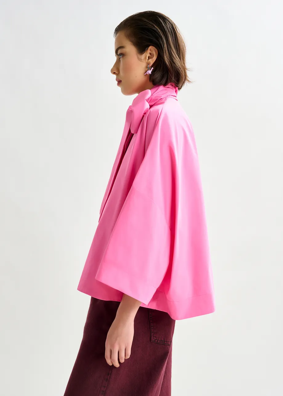 Pink pussy-bow top with trumpet sleeves