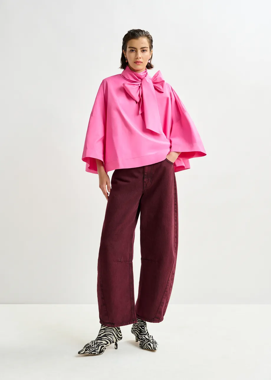 Pink pussy-bow top with trumpet sleeves