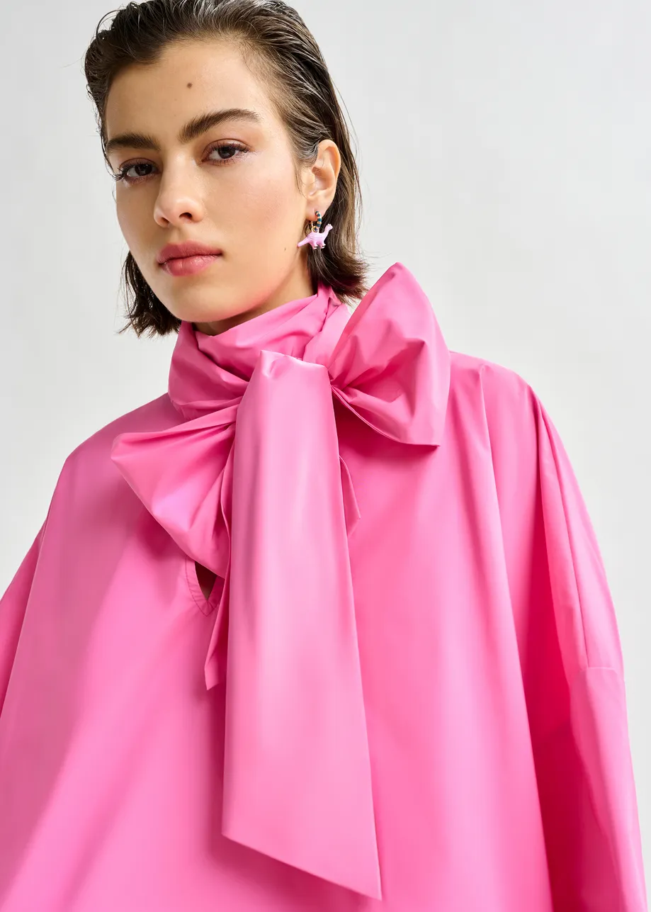 Pink pussy-bow top with trumpet sleeves