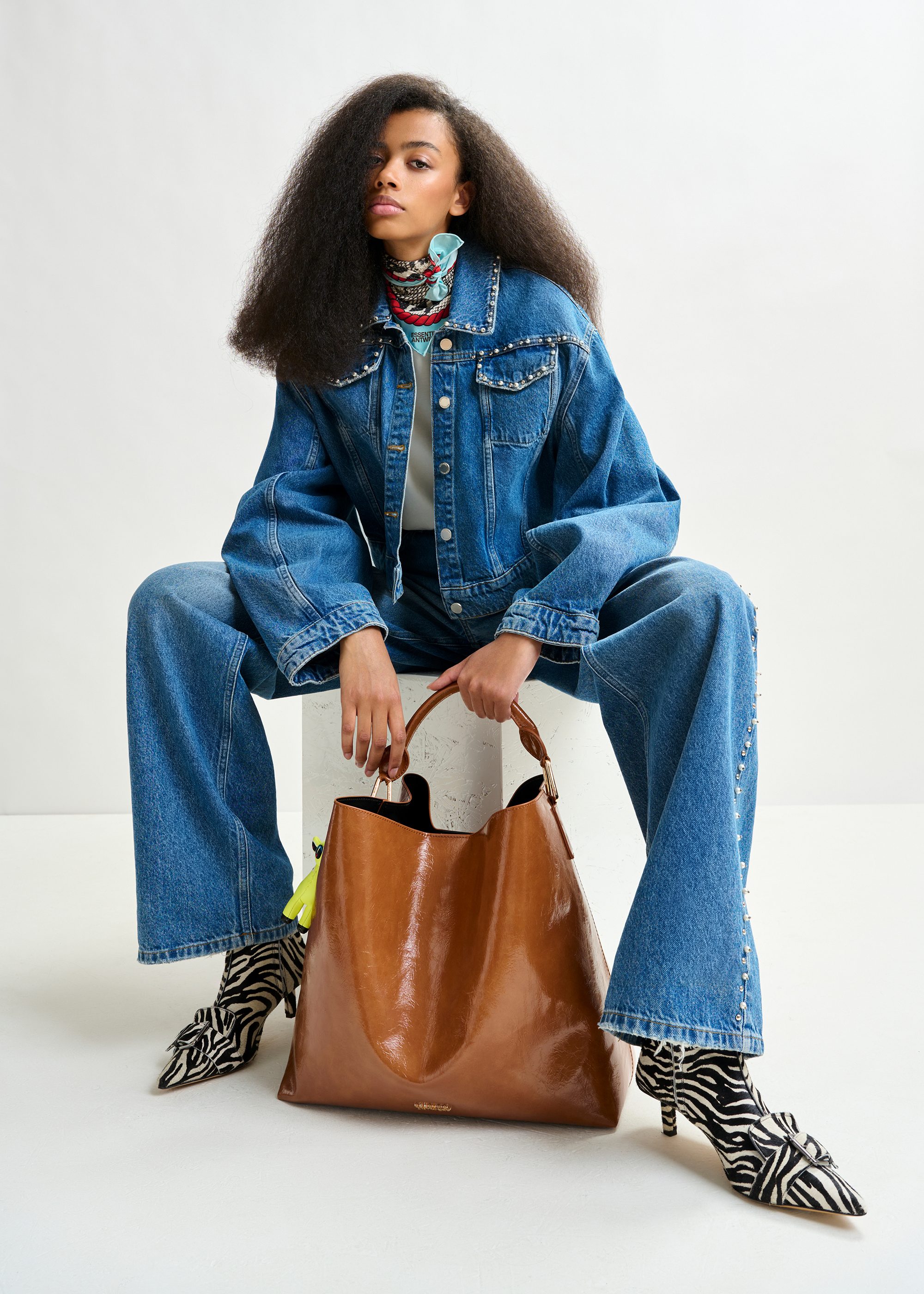 Blue cropped denim jacket with pearl and stud embellishments