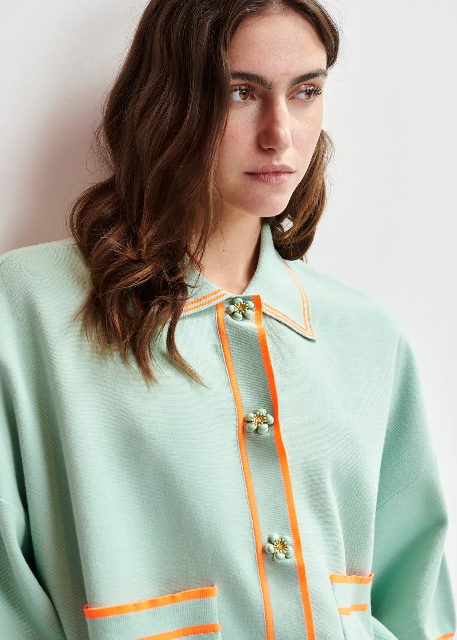 Light blue and orange knit cardigan with flower buttons and contrasting trims