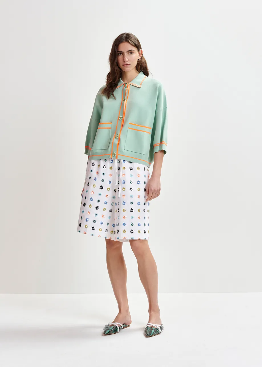 Light blue and orange knit cardigan with flower buttons and contrasting trims