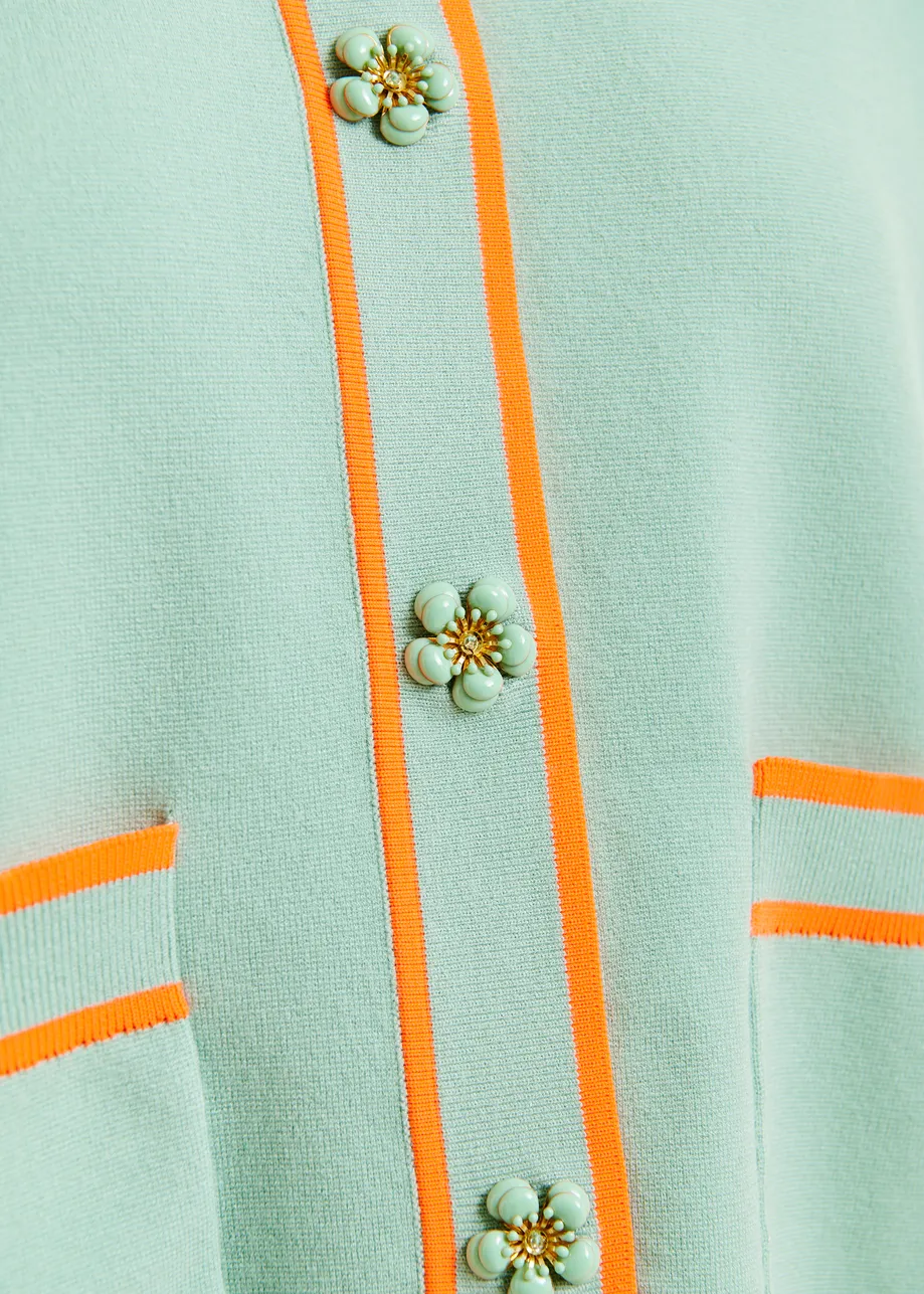 Light blue and orange knit cardigan with flower buttons and contrasting trims