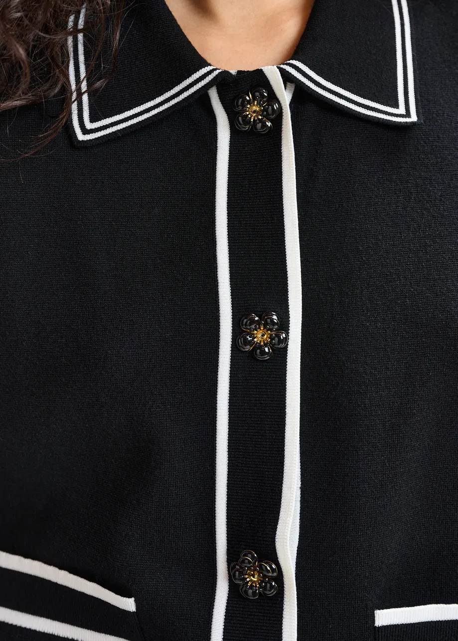 Black and white knit cardigan with flower buttons and contrasting trims