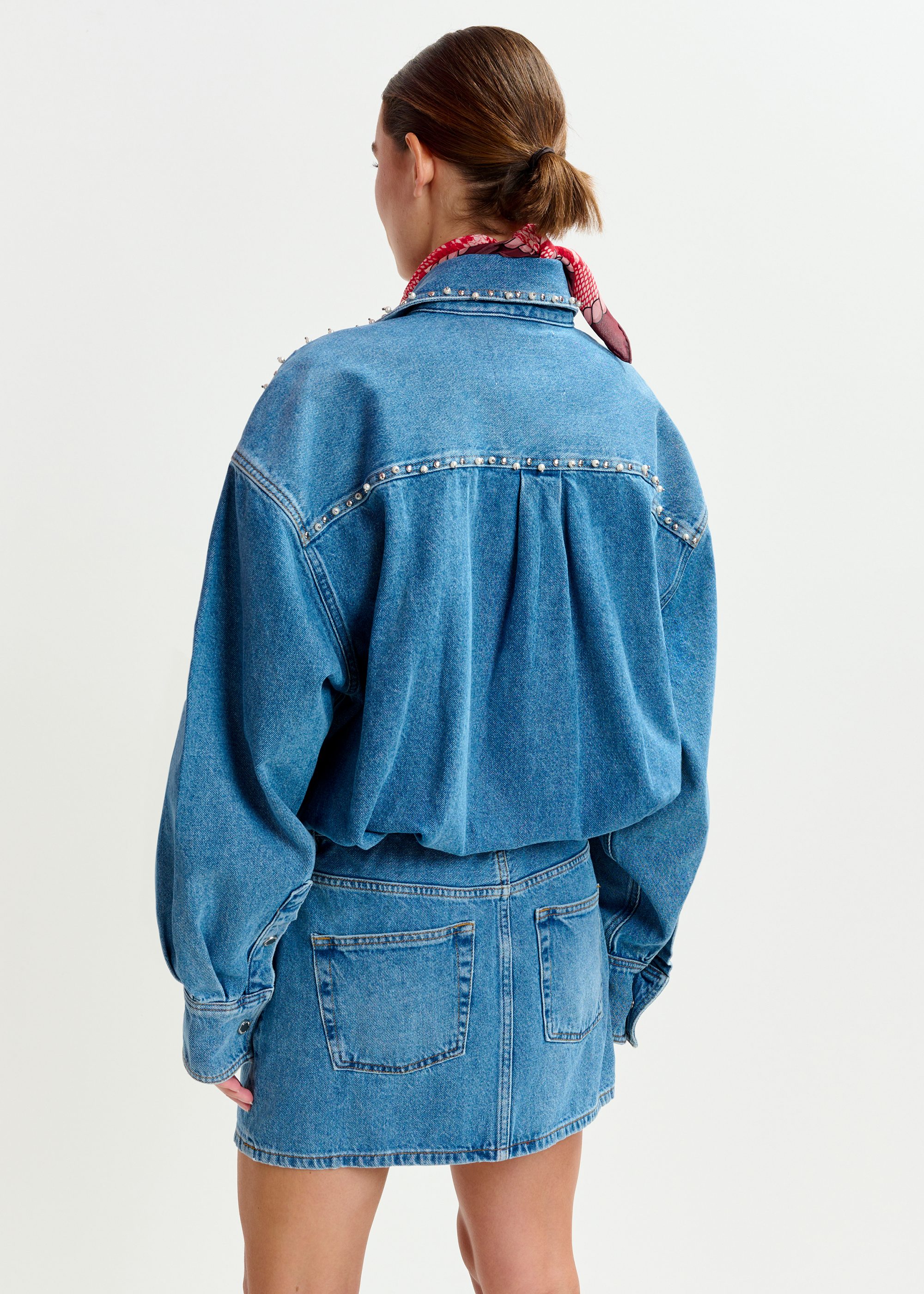 Blue two-piece denim set with pearl and stud embellishments