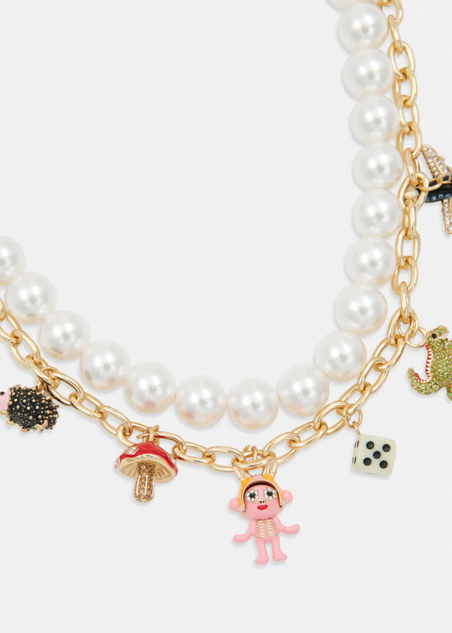 Gold and off-white double-strand necklace with pearls &  charm pendants