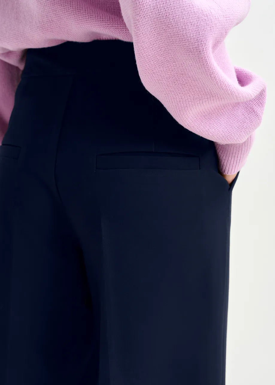 Navy cropped pants with folded cuffs