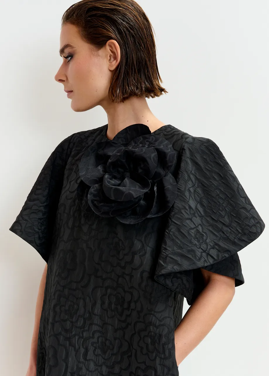 Black jacquard A-line mini dress with flower brooch