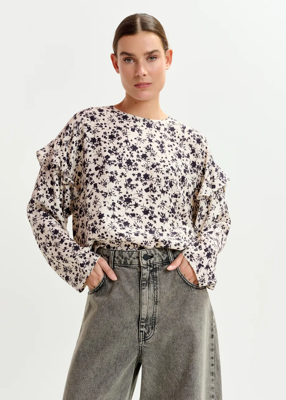Off-white and black floral top with ruffle detail