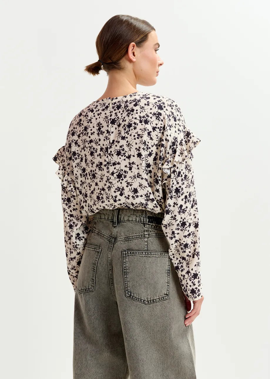 Off-white and black floral top with ruffle detail