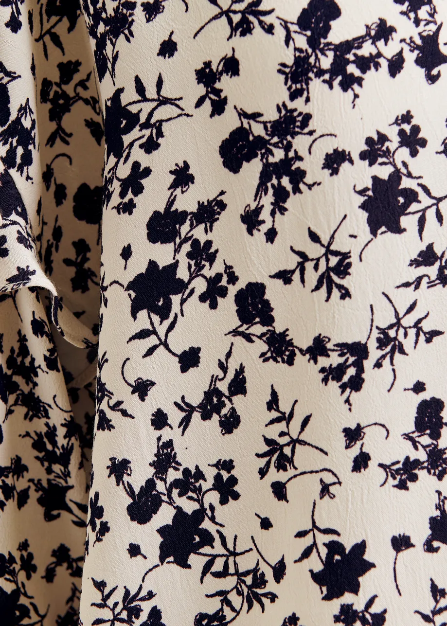 Off-white and black floral top with ruffle detail