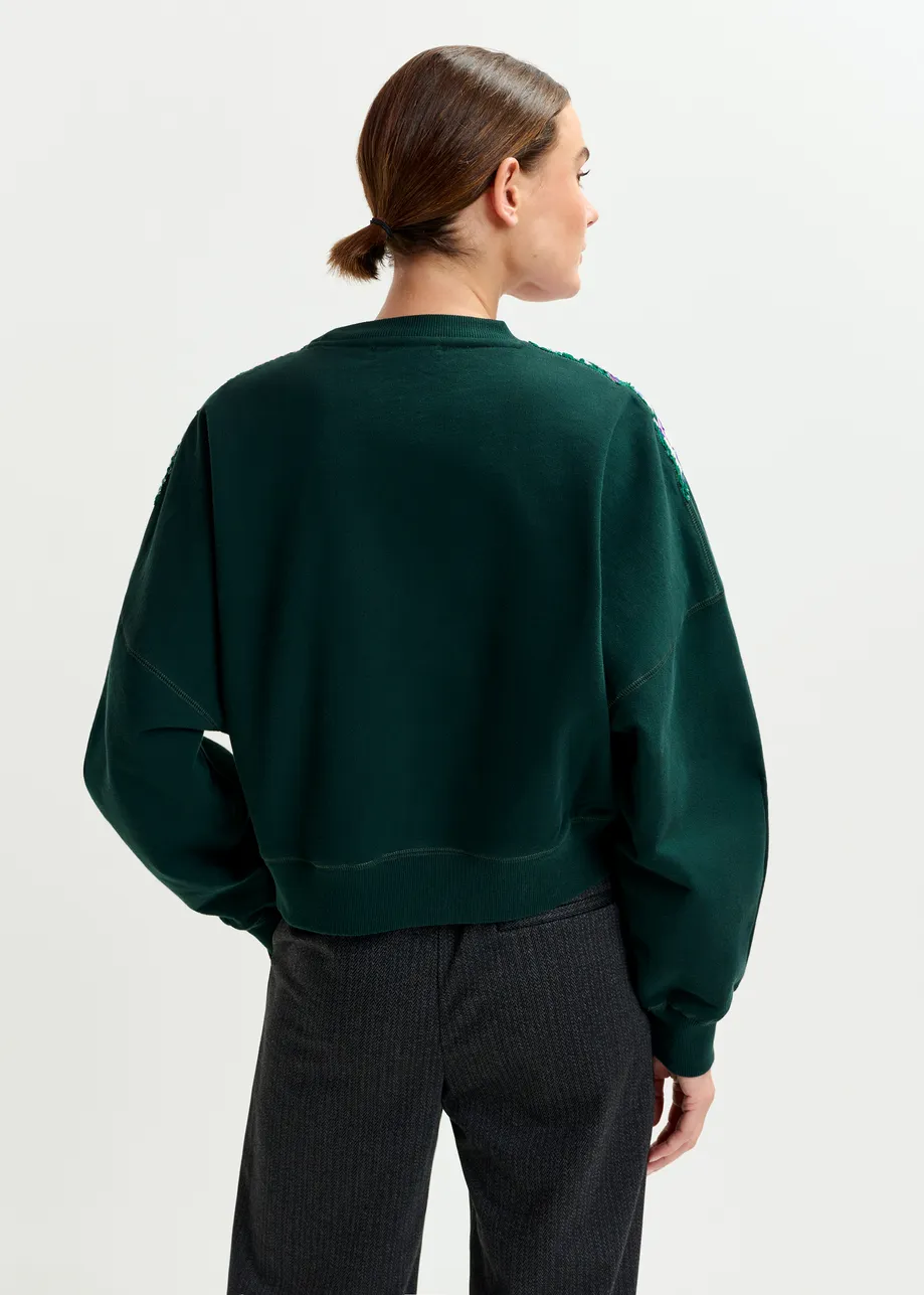 Donkergroene sweater met veelkleurige pailletten