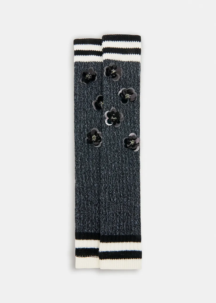 Grey, black and white rib-knitted warmers with rhinestone and sequin embellishments