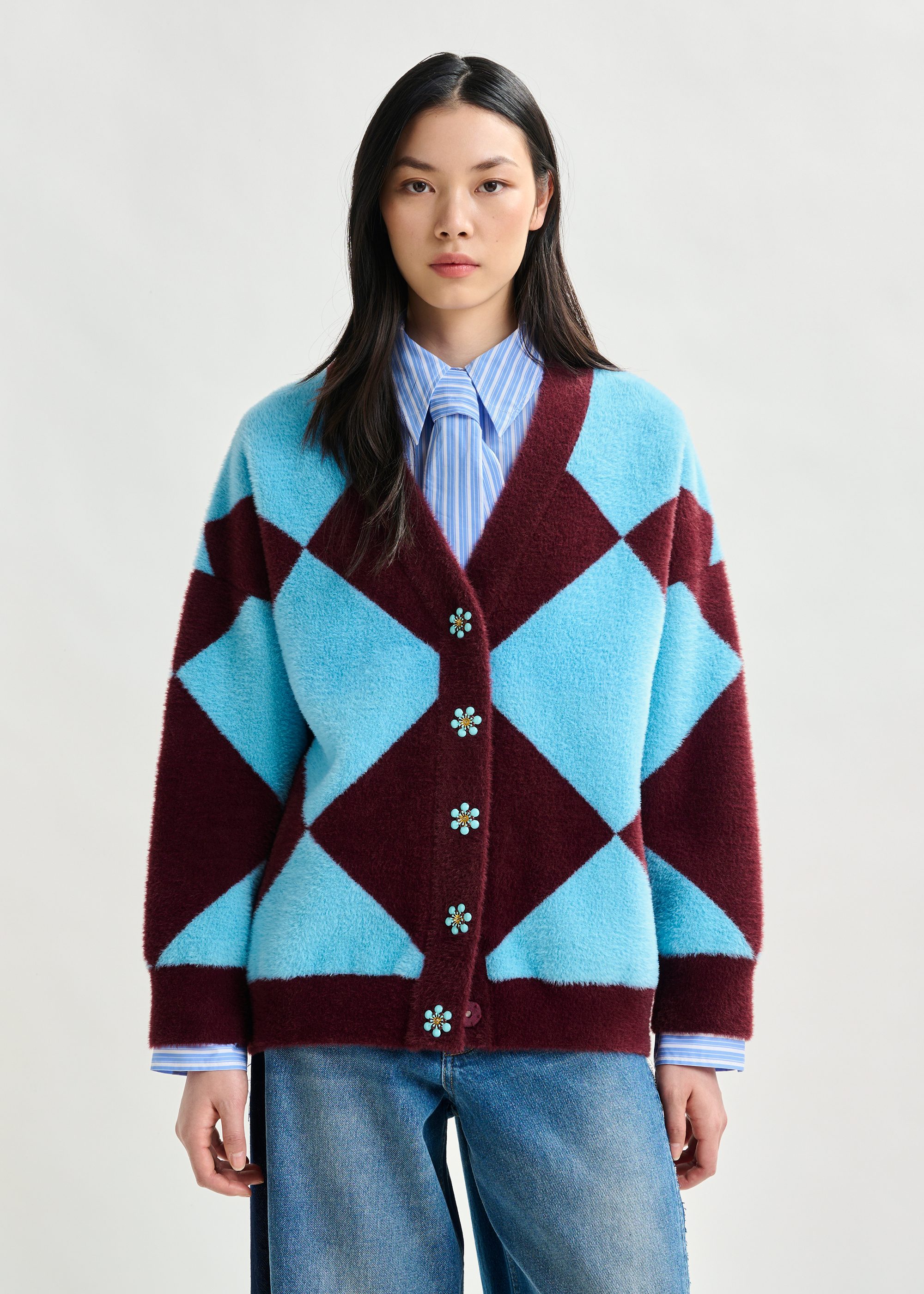 Blue and burgundy harlequin-patterned knit cardigan with flower