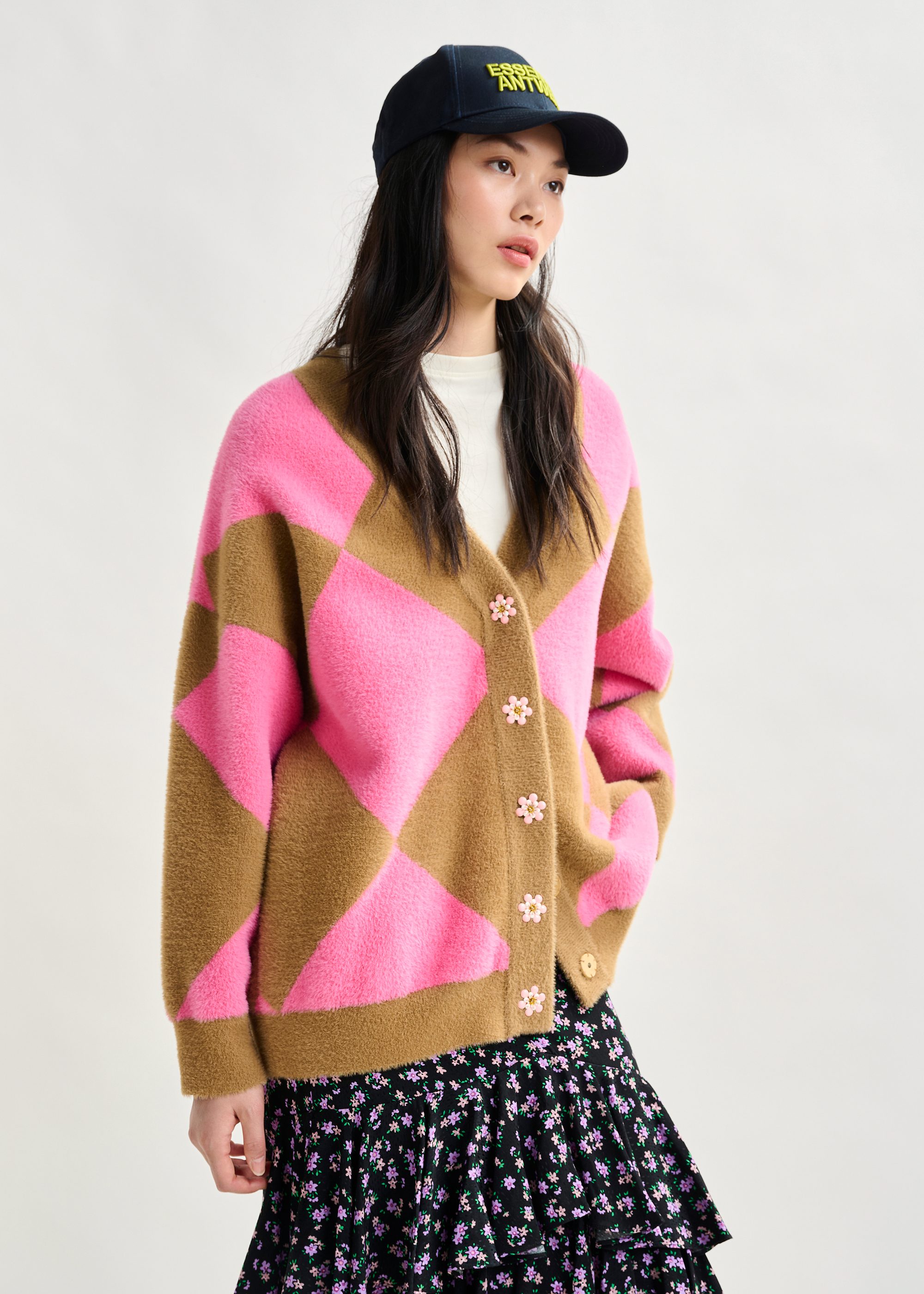 Brown and pink harlequin-patterned knit cardigan with flower