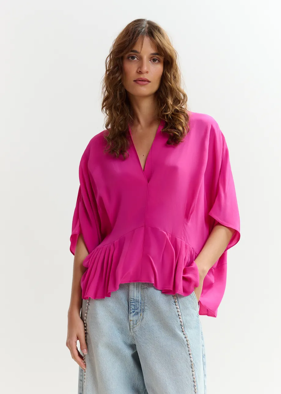 Roze oversized top met peplumzoom