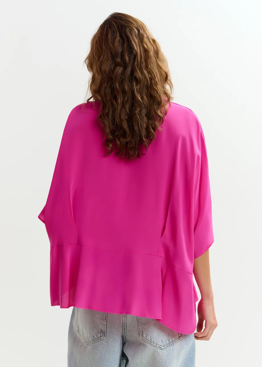 Roze oversized top met peplumzoom
