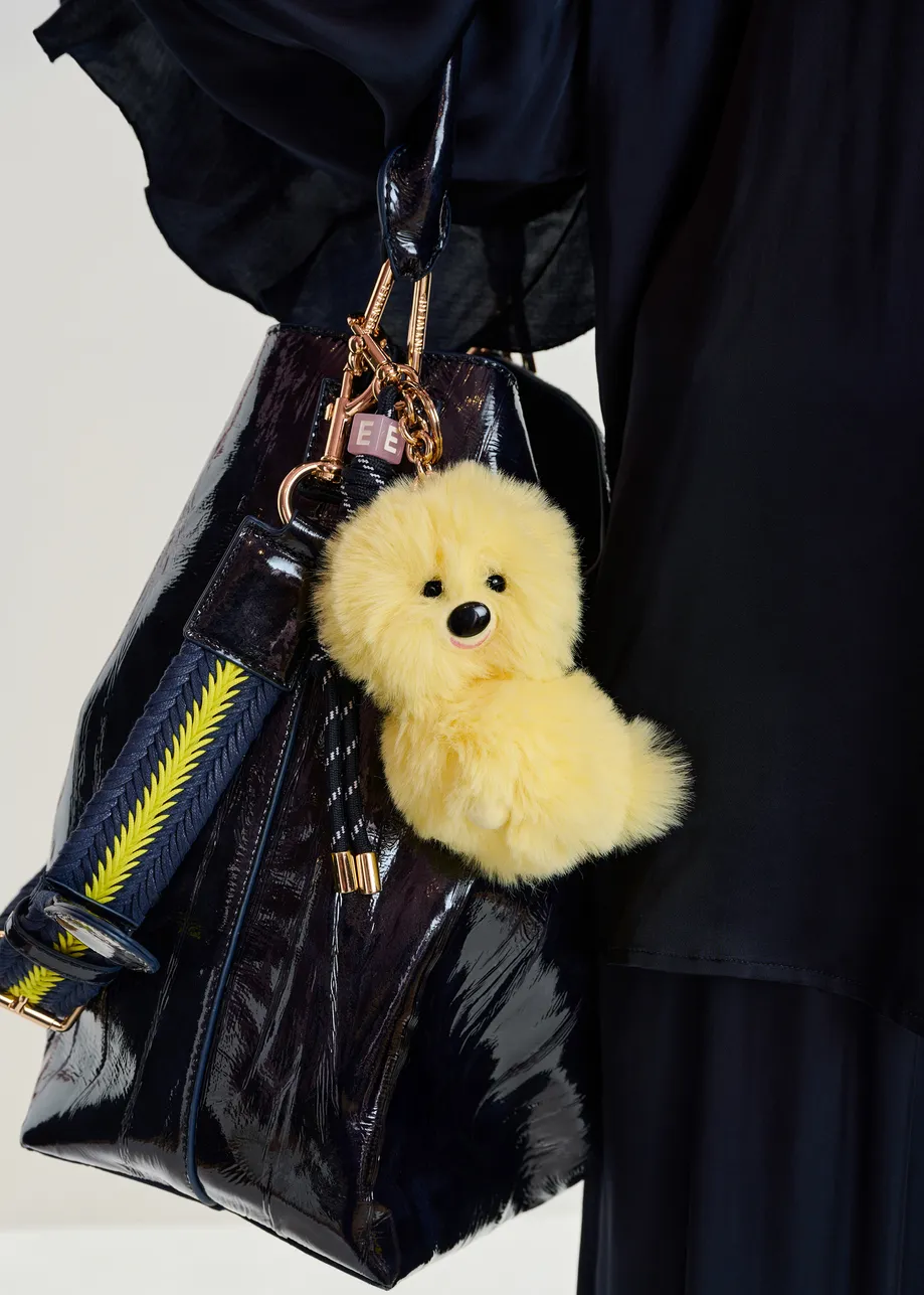Yellow dog bag charm with black twisted cord detail