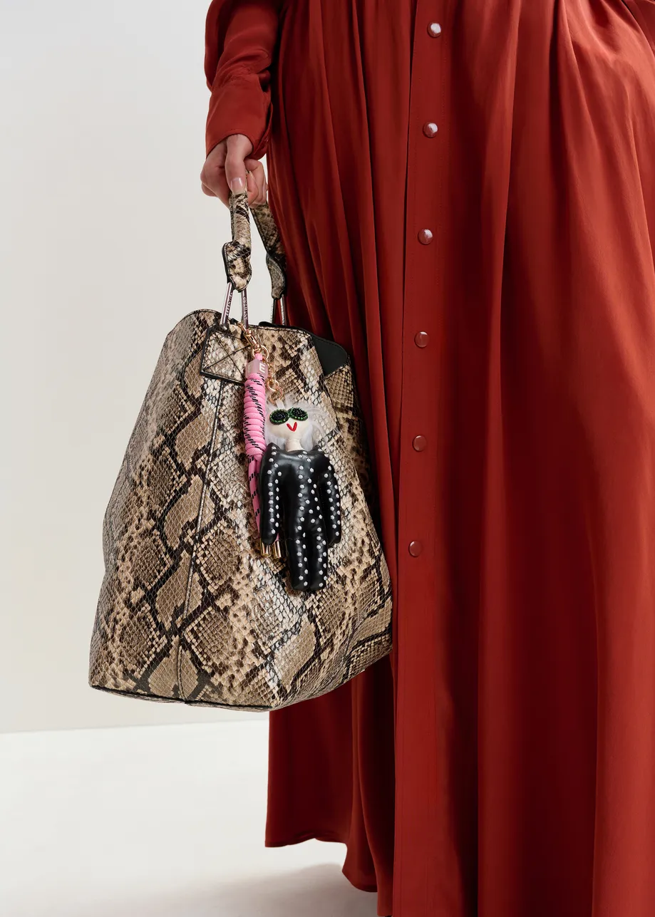 Black doll bag charm with pink twisted cord detail