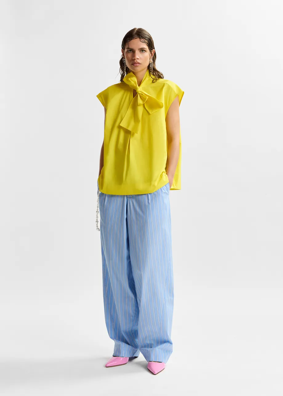 Yellow sleeveless top with tie neckline