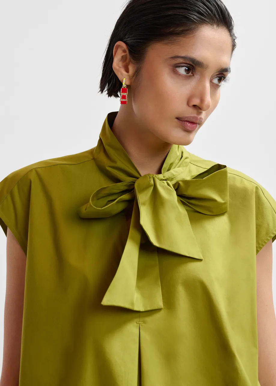 Green sleeveless top with tie neckline