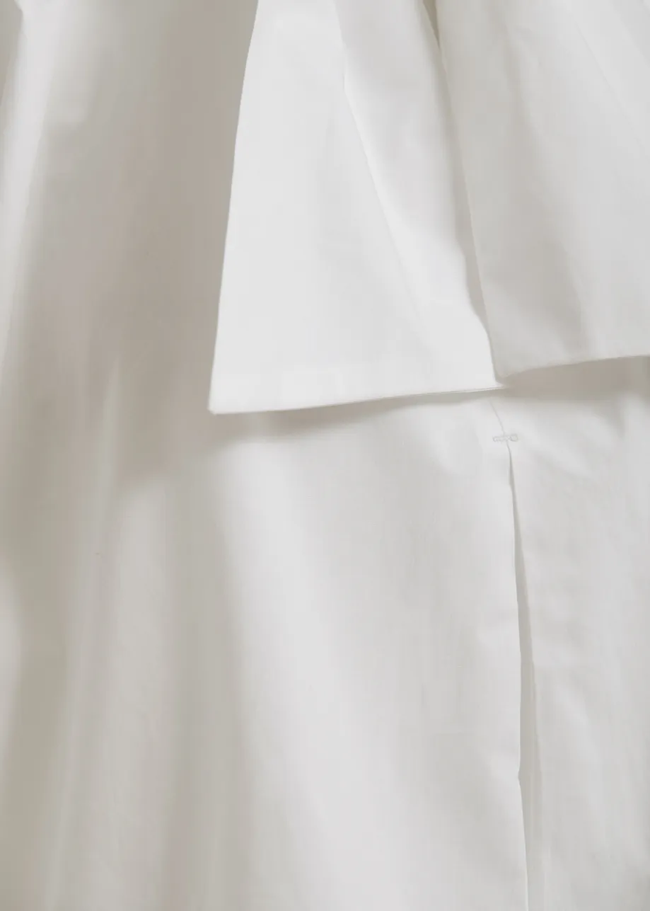 Off-white sleeveless top with tie neckline