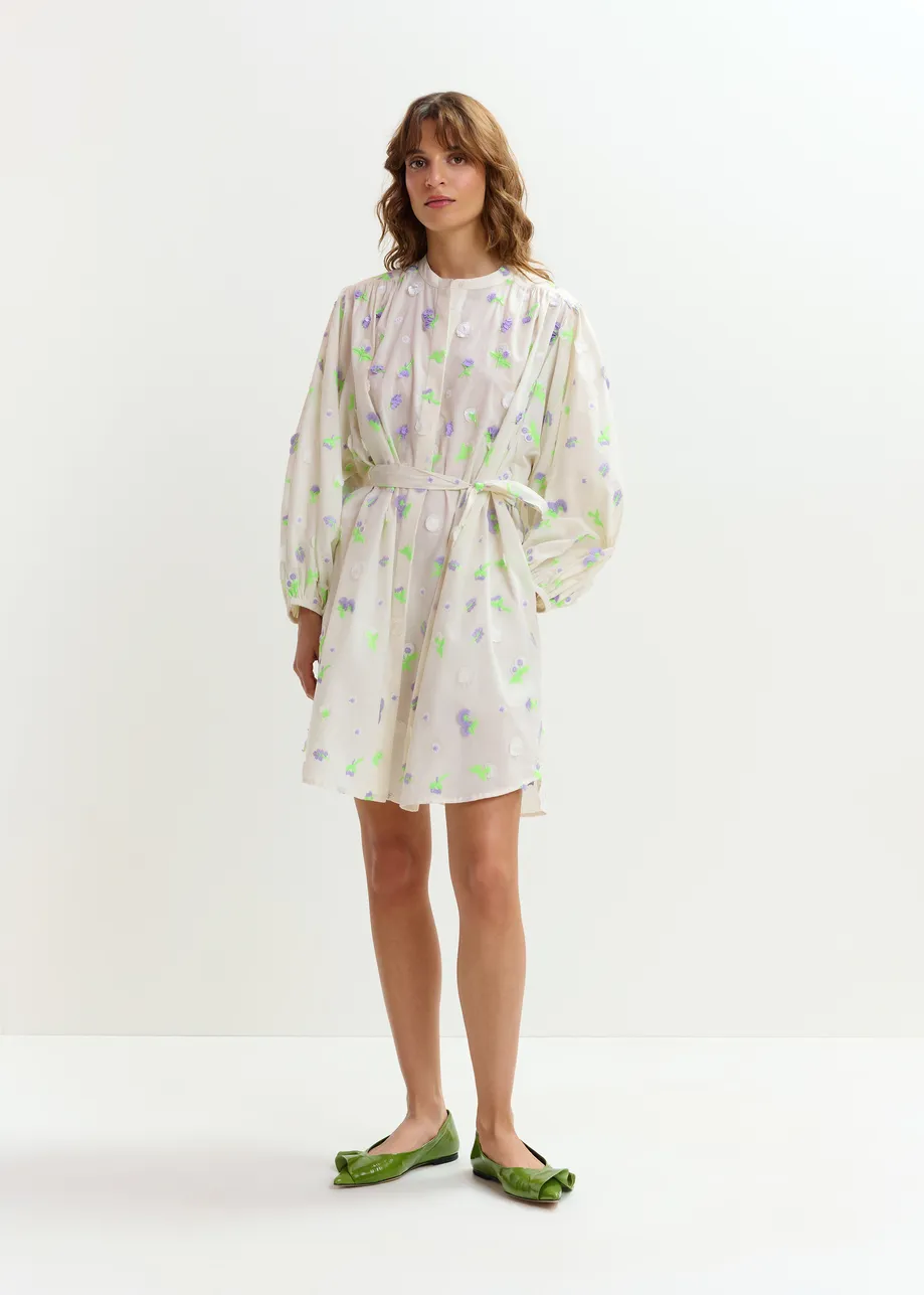 Off-white knee-length dress with mandarin collar and purple and green embellishments