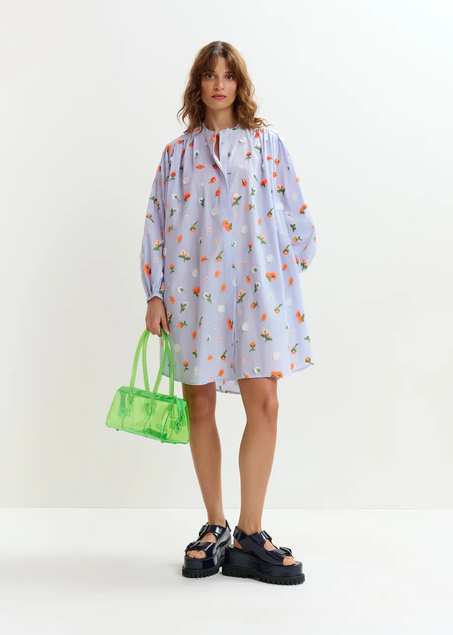 Light blue knee-length dress with mandarin collar and green and orange embellishments