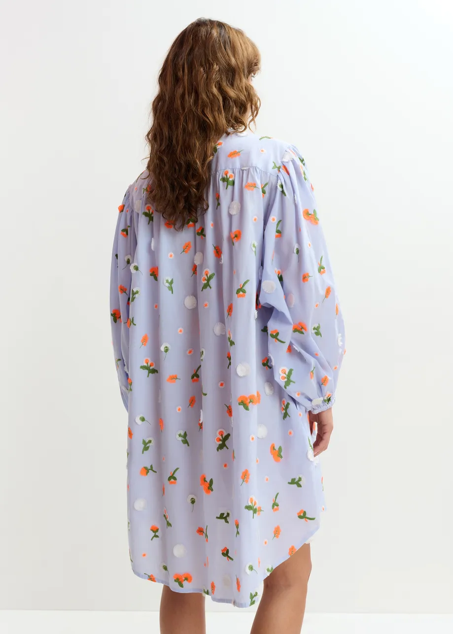 Light blue knee-length dress with mandarin collar and green and orange embellishments