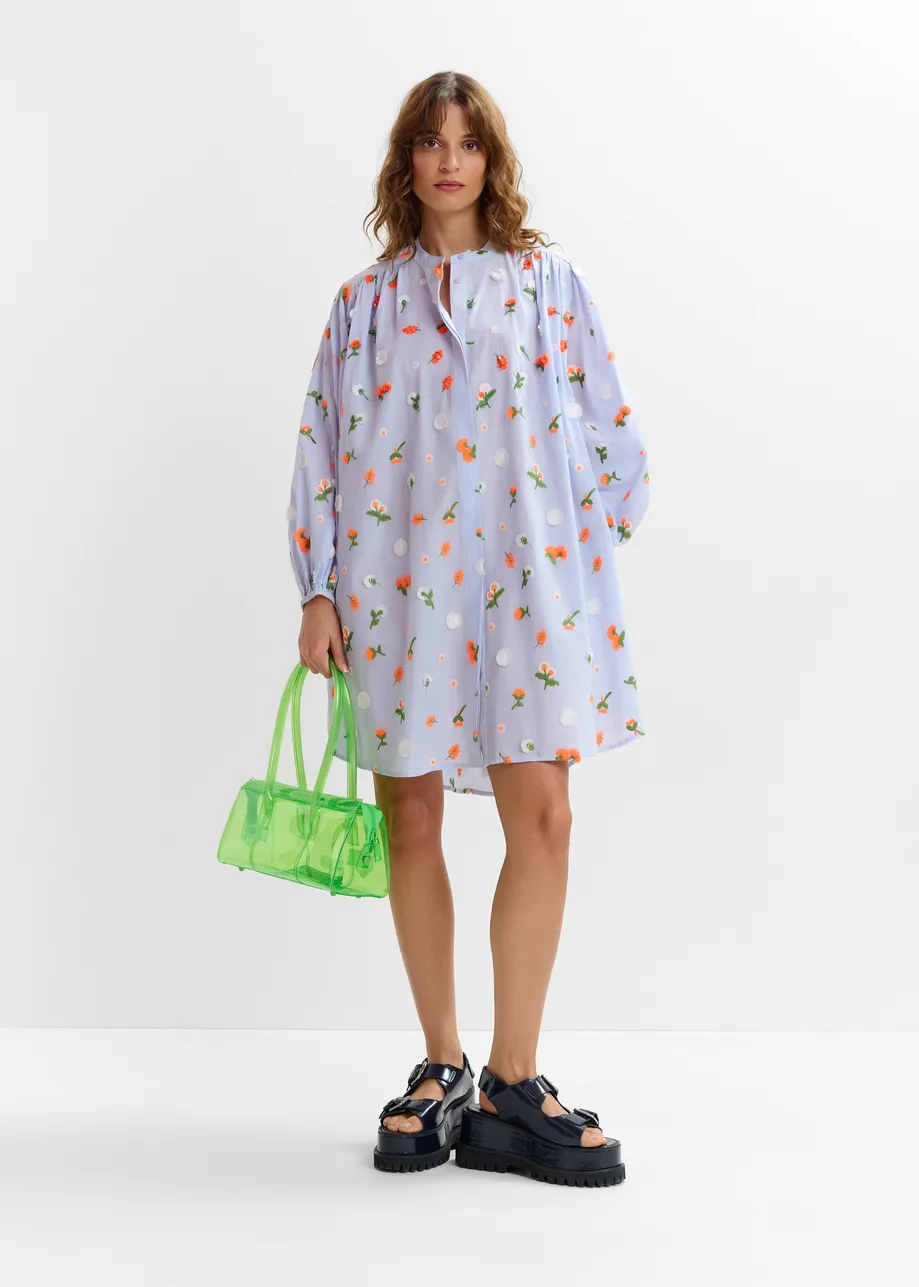 Light blue knee-length dress with mandarin collar and green and orange embellishments