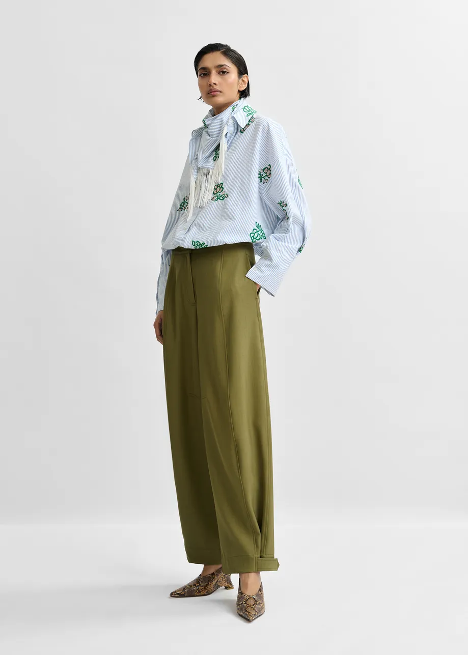 Olive green barrel-leg pants with twisted side seams