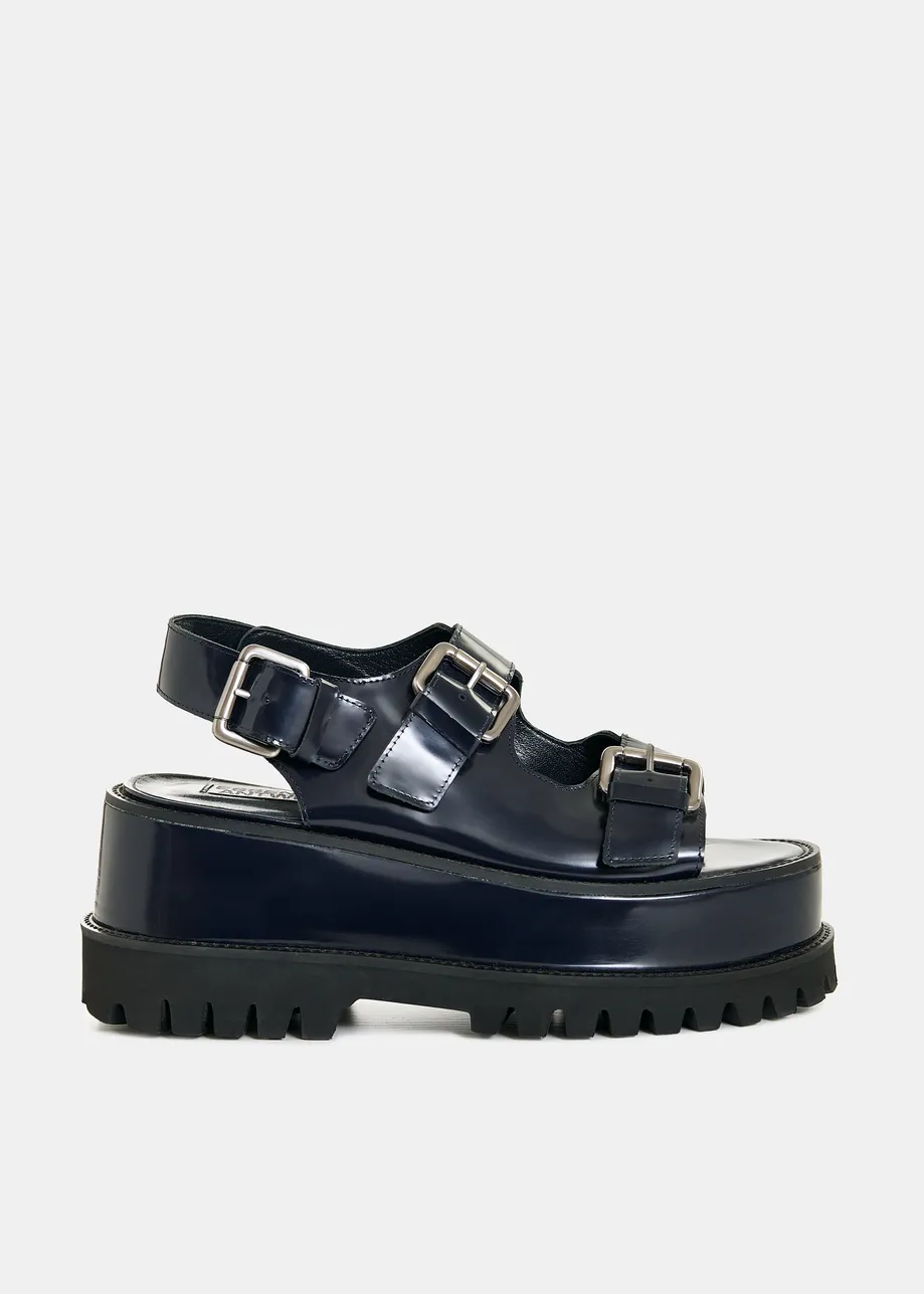 Black chunky leather platform sandals with silver buckle details