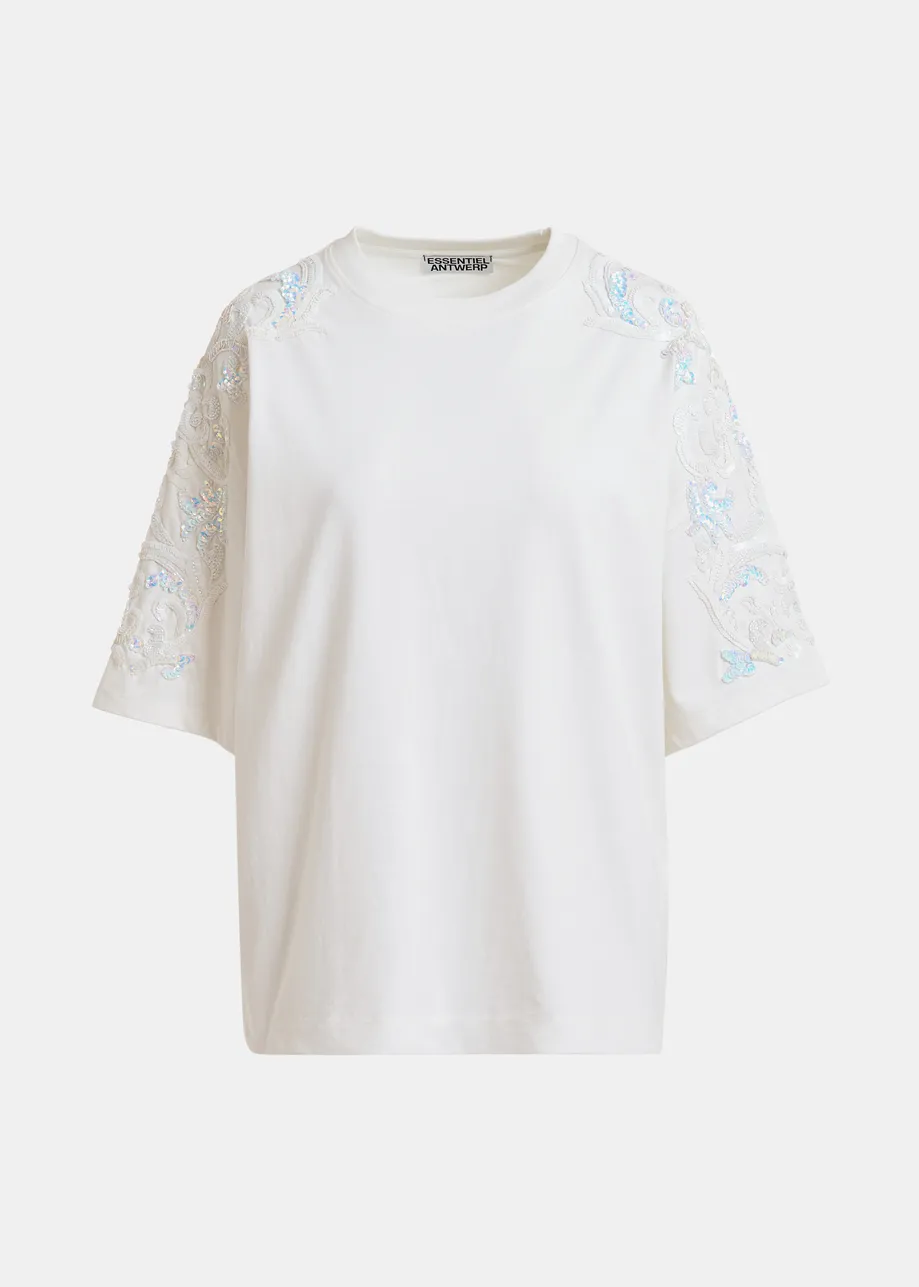 T-shirt in cotone avorio chiaro  con decorazioni in paillettes e perline