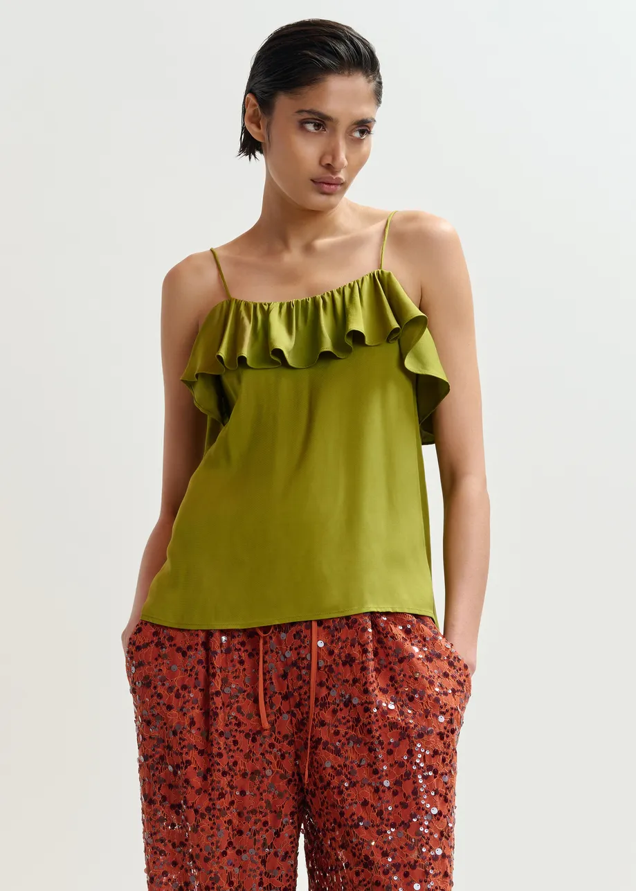 Groen topje met volant en lint op de rug